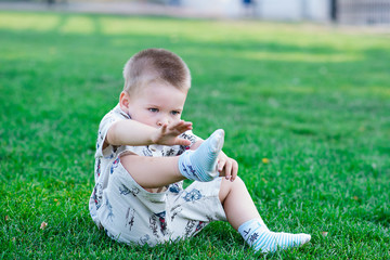 child takes sock with foot