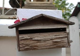Wooden mailbox on white wall background