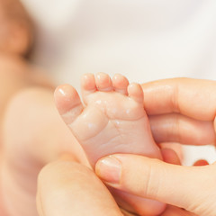 Mother makes massage for newborn baby