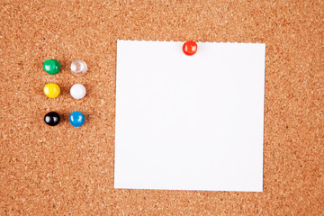 Cork bulletin board with notes.