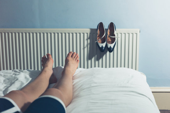 Woman resting on bed after walking in high heels