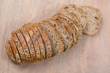 Brown slices of bread isolated over wooden brown  background