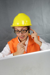 Surprised builder with computer.