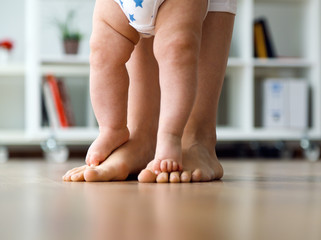 Mother and baby legs. First steps.