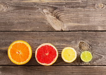 Set of sliced citrus fruits over wooden background