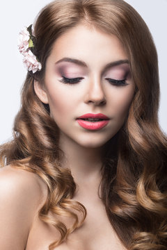 girl with flowers in her hair and pink makeup. 