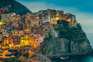 Fototapeta na wymiar Town on the rocks at night Liguria Italy