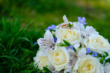 Wedding rings on a beautiful wedding bouquet 