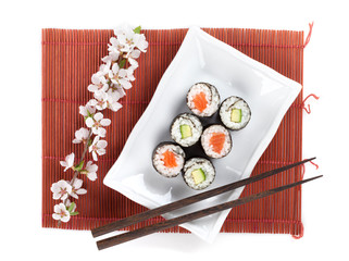 Sushi maki set with salmon and cucumber and sakura branch