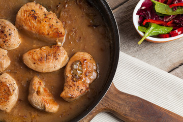 Veal in gravy on a pan.
