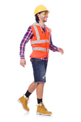 Walking young construction worker isolated on white