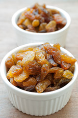 Heap of Raisins on vintage wooden background