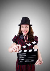 Woman gangster with movie board on white
