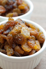 Heap of Raisins on vintage wooden background