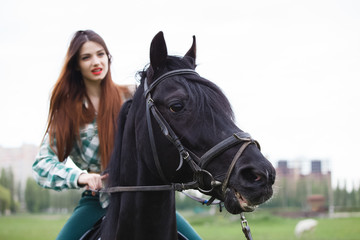 Obraz premium beautiful girl riding a horse