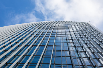 A clouds reflection in glass wall of business building