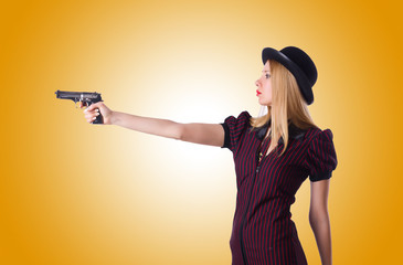 Woman gangster with handgun on white