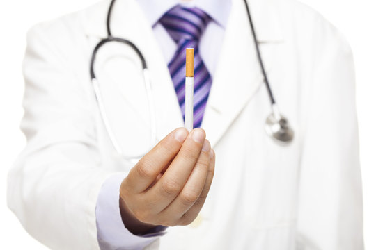 Doctor with stethoscope holding cigarette