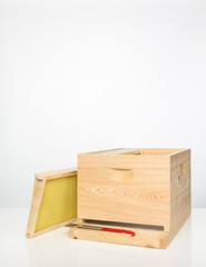 Parts of Langstroth beehive with hive  tool and frames.