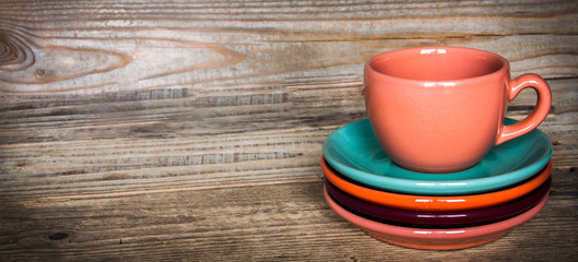 set of colorful cups and dishes and dessert