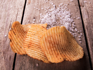 Heap of Paprika Potato Chips on rustic background