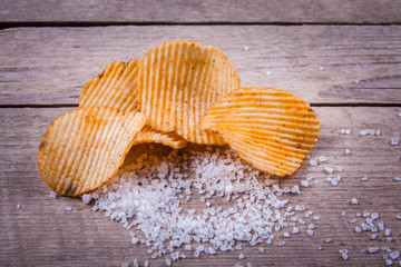 Heap of Paprika Potato Chips on rustic background