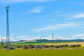 Fototapeta premium solar panels on a green field against the sky
