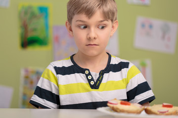 Schoolboy with breakfast at school