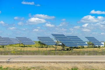 solar panels on a green field against the sky
