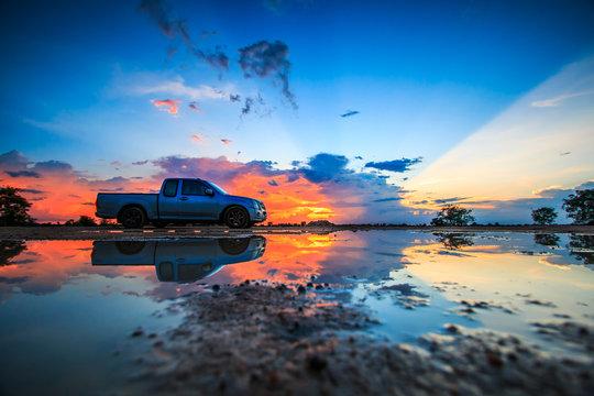 Car and sunset sky