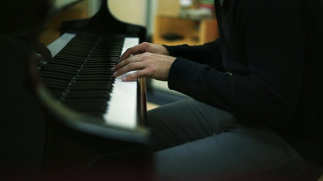 Musician's Hands as he Plays Piano in a Studio