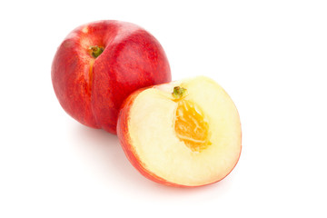 White nectarine whole and sliced over white