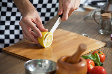 Chef sliced lemon by knife