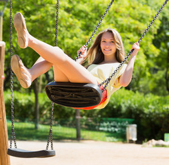 Woman on swing in summer