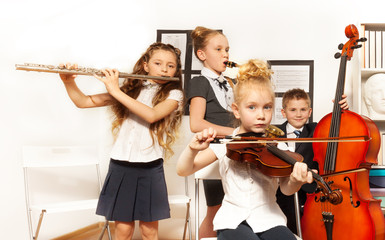 School children play musical instruments together