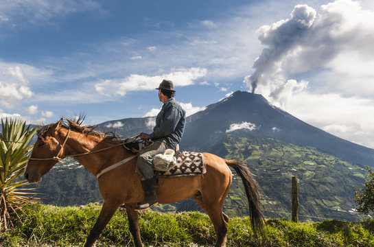 Fototapeta Unrecognizable farmer on a horse front of volcano Tungurahua