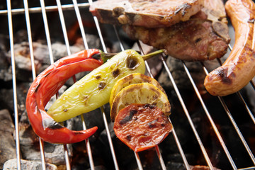 vegetables grilled and sausages and prok chop on the grill