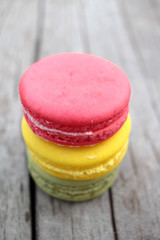 Macaroons colorful delicious on wood background.