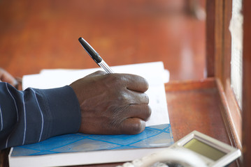 Black man hand with pen 