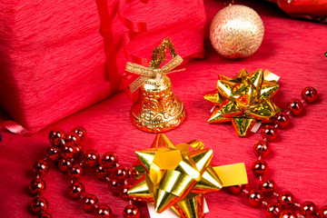 golden bell near red bead and golden bow