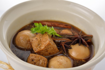 hard boiled eggs stew with sweet brown gravy in bowl