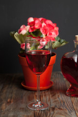  glass with red wine and flower