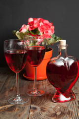 Bottle with red wine and flower