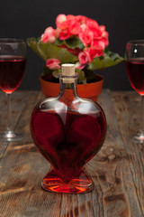 Bottle with red wine and flower