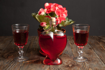 Bottle with red wine and flower