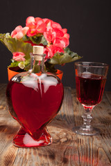 Bottle with red wine and flower