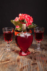 Bottle with red wine and flower
