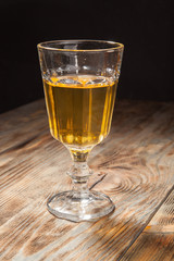 Glass with white wine on a wooden table