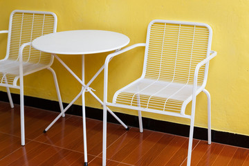 white chair and desk with yellow wall