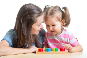 child and mom playing together with puzzle toy